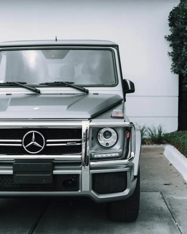 Front view of a grey Mercedes-Benz G-Class parked in an urban setting.